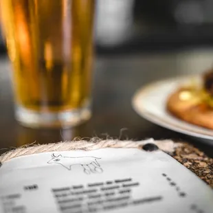 a menu and a glass of beer