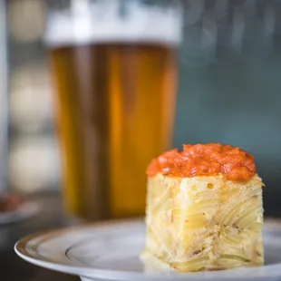 a plate of food and a glass of beer