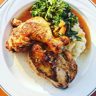 Roasted half chicken with jus, wilted kale salad, and mashed potatoes