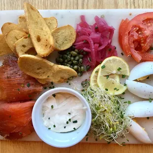 Smoked Salmon board with Scottish and pastrami salmon and decadent bagel toasts. A good meal in itself or easily shared.