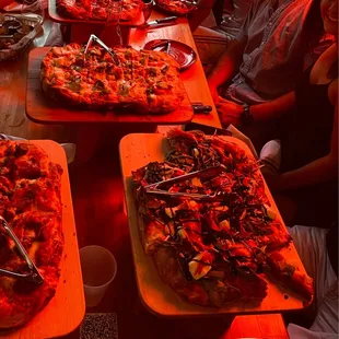 a table full of pizzas