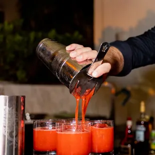 a bartender pouring a drink