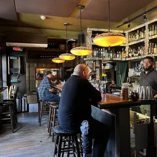 a group of people sitting at a bar