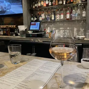 a glass of wine and a menu