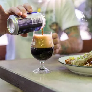 a man pouring a drink