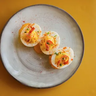 three deviled eggs on a plate