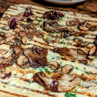  flatbread pizza with mushrooms on it