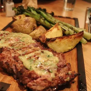 teak and potatoes on a cutting board