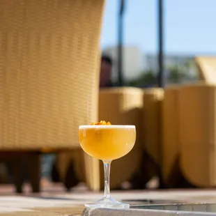 a glass of orange juice sitting on a table