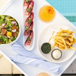 Sunshine, dishes and drinks poolside