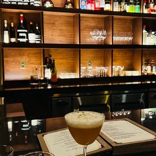 a cocktail in a glass on a bar