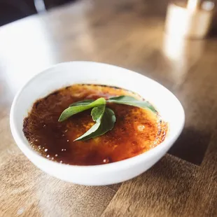 a bowl of soup on a wooden table