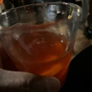 a person holding a glass of beer