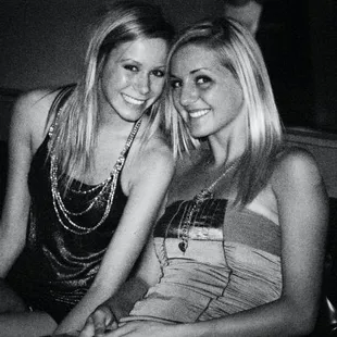 two women sitting on a couch