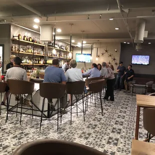 people sitting at tables in a restaurant
