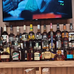 a large collection of liquor bottles