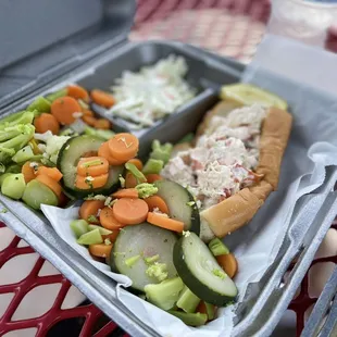 a tray of vegetables and a sandwich