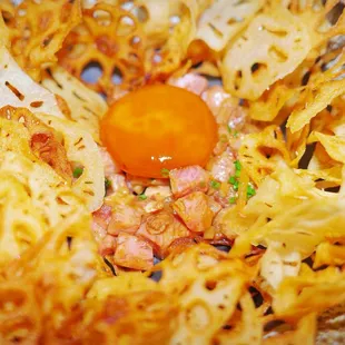 WAGYU TARTARE A5 wagyu. cured jidori yolk. awase miso. fish garum. house pickles. chive. lotus root chips.