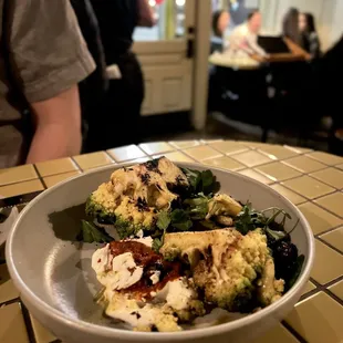 Grilled Romanesco Cauliflower, Harissa, House Yogurt, Charred Dates, and Carrot Vinaigrette