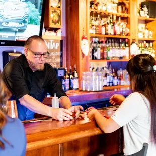 a man and a woman at a bar