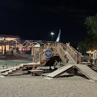 a wooden play structure with stairs