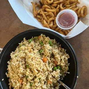 Crawfish fried rice and curly fries.