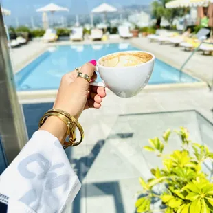 a person holding a cup of coffee