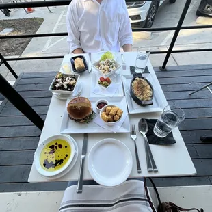 a man sitting at a table with food on it