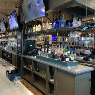 people sitting at the bar and watching televisions