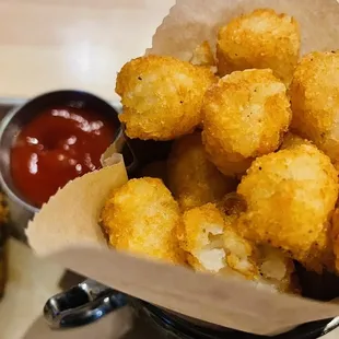 a basket of tater tots and a burger