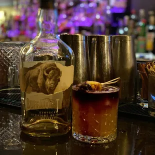 a bottle of bourbon and a cupcake