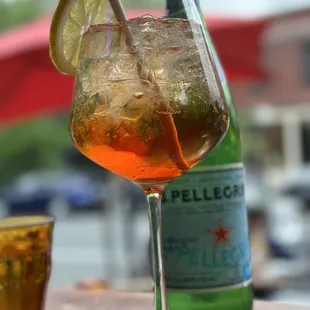 a bottle of pelleccino and a glass of water