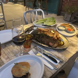 27oz ribeye, burger, ceaser salad and wine
