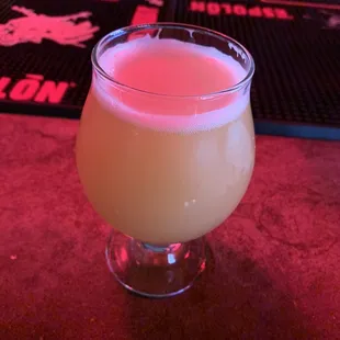 a drink in a glass on a bar