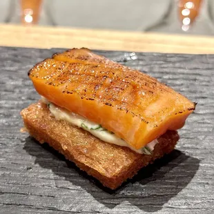Eat this snack last. A piece of fried shokupan bread w grilled salmon on wasabi cream cheese.