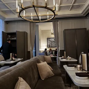 people sitting at tables and a chandelier