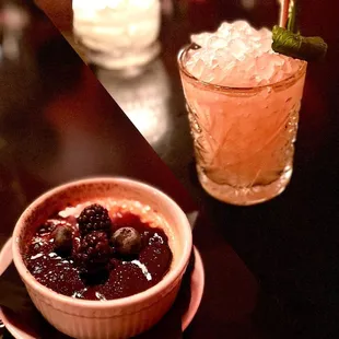 a small bowl of fruit and a drink