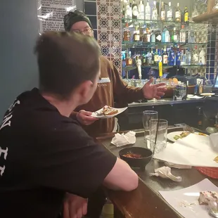 a man serving food to a woman