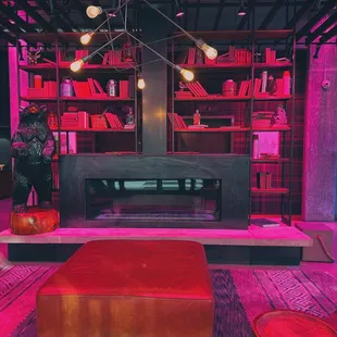 a red couch and a fireplace