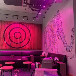 purple lighting and a mural of an elephant