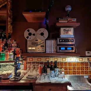 a bar counter with a lot of bottles and glasses on it