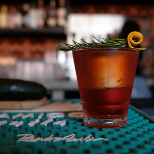 a drink with a lemon garnish