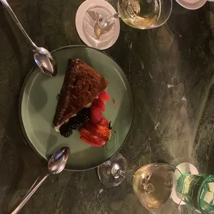 a slice of cake and a glass of wine