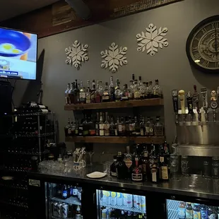 shelves of liquor and a television