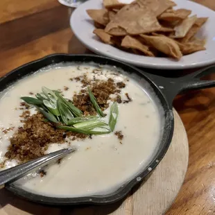 a bowl of soup and a plate of tortillas