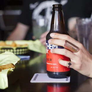 a person holding a bottle of beer