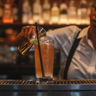 a bartender pouring a drink