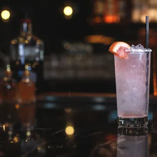 a cocktail with a slice of grapefruit