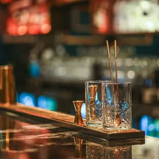 a shot of two glasses on a bar counter