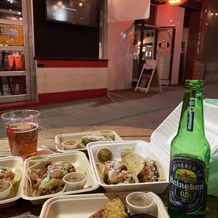 a tray of food and a bottle of beer